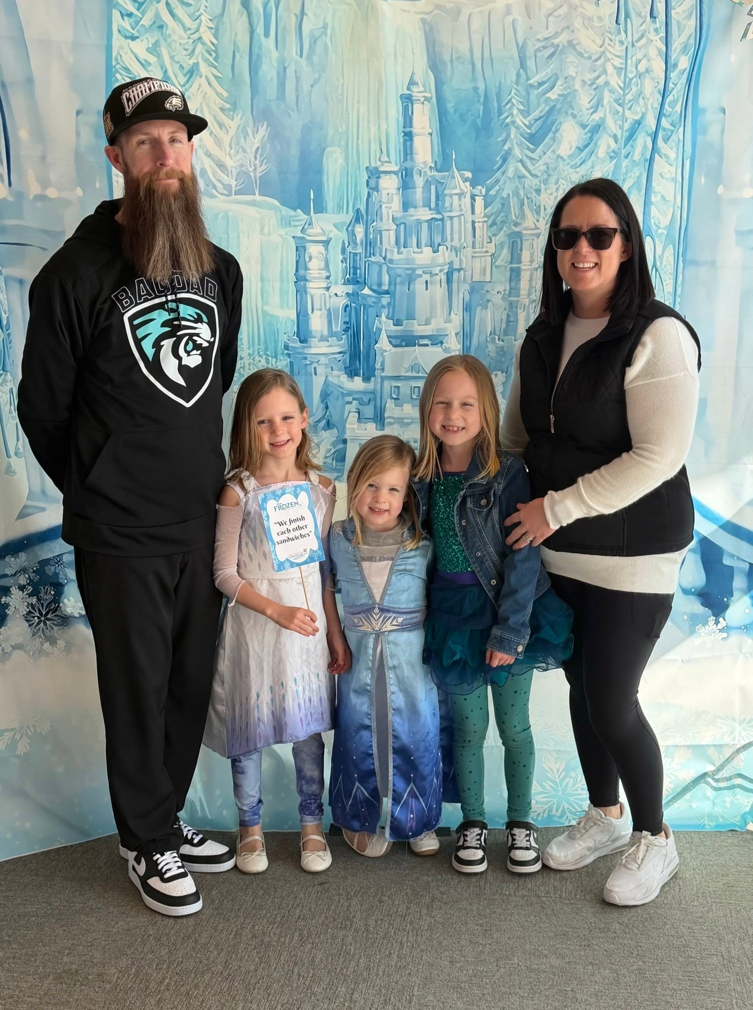 Gilligan with his wife and three daughters in front of an icy castle backdrop